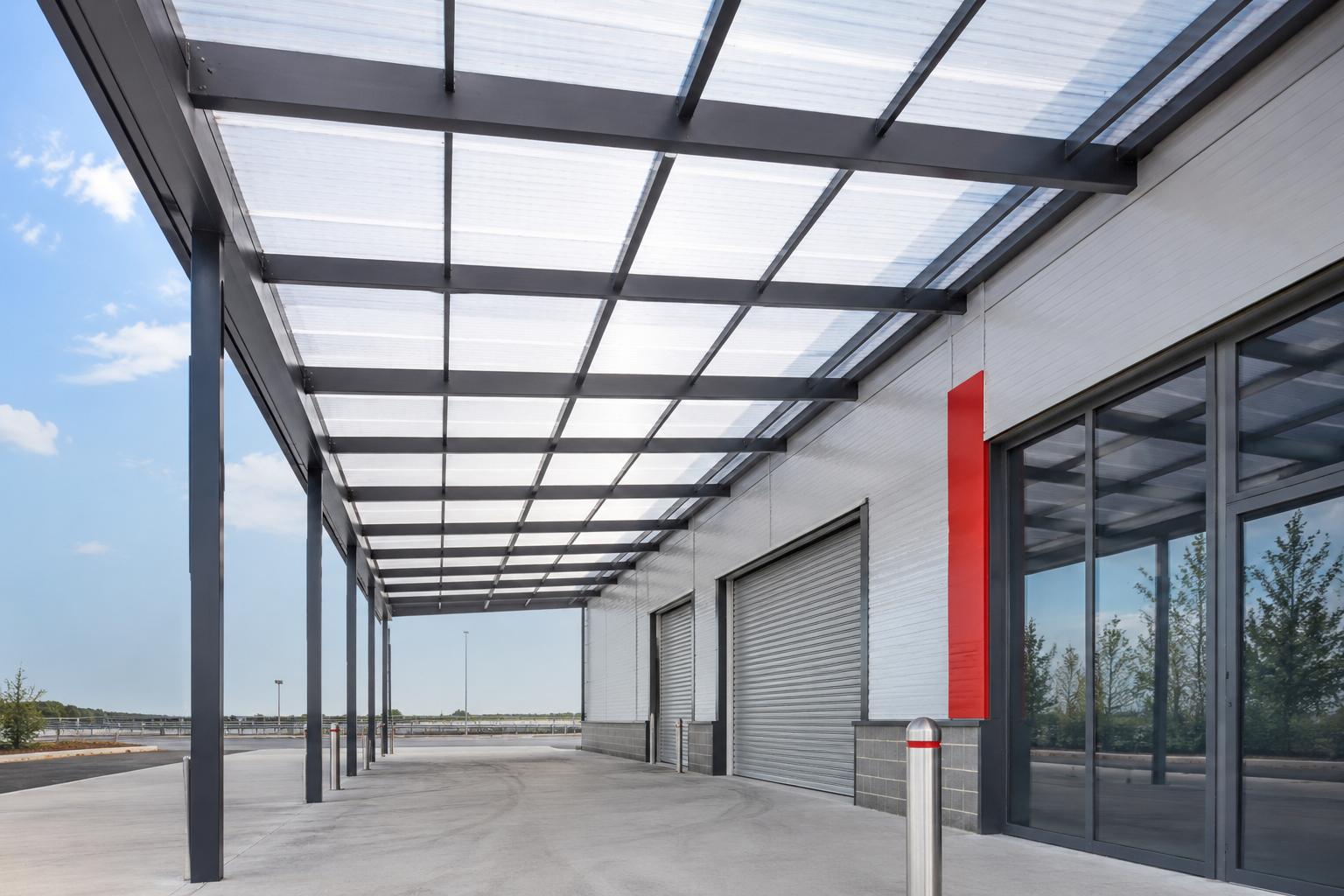 Polycarbonate roofing system installed over an industrial building walkway